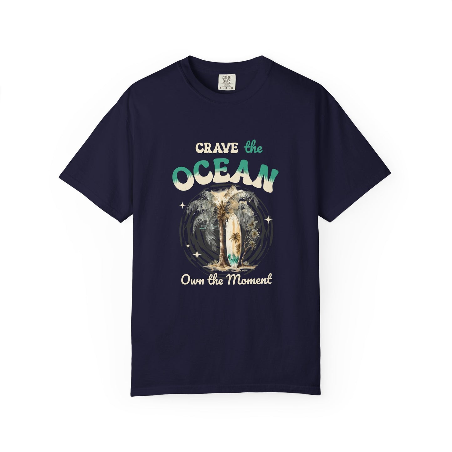 A navy blue short-sleeve t-shirt with a graphic on the front that reads 'CRAVE the OCEAN Own the Moment' around an illustration of a surfer riding a wave. Crave the Ocean Own the Moment Graphic T-Shirt for Casual Wear