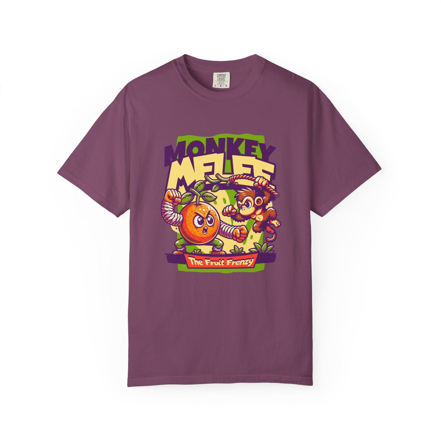 A purple short-sleeve crewneck t-shirt featuring a colorful cartoon graphic on the front with the text 'MONKEY MELEE' and 'The Fruit Frenzy' depicting a monkey, a banana, and a pineapple. Wild Fruit Frenzy: Monkey-Themed T-Shirt Design