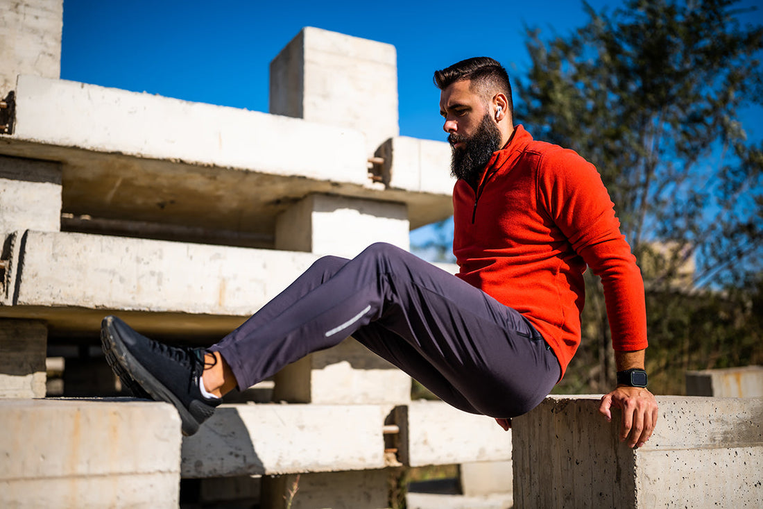 Young man is exercising outdoor he is doing reverse pushups