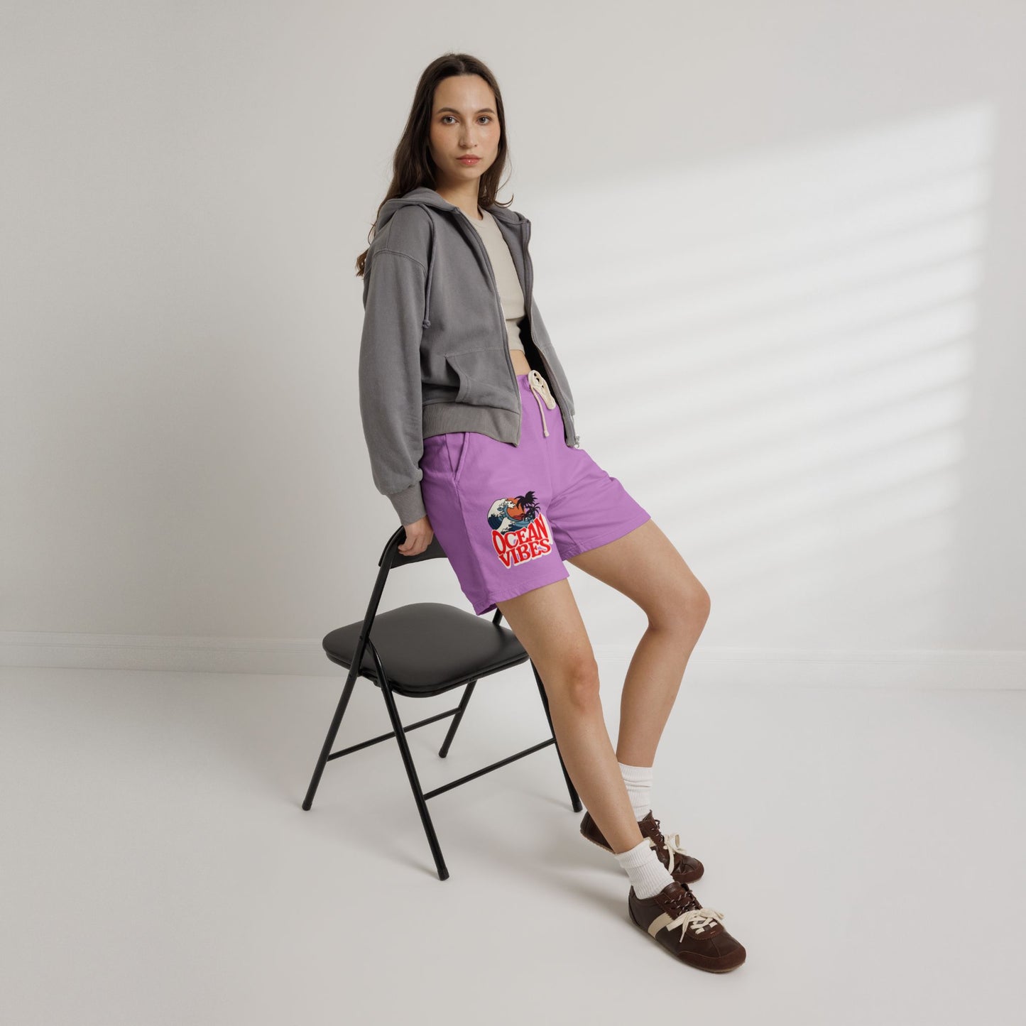 Person wearing a gray hoodie and purple shorts with a colorful design, standing on a white background. Unique Lightweight Fleece Sweat Shorts in Ocean Vibes Graphic Shop Lightweight Fleece Sweat Shorts in Ocean Vibes for breezy comfort, relaxed style, and an easygoing summer-ready look all day. Refresh your casual rotation with Lightweight Fleece Sweat Shorts in Ocean Vibes—soft, versatile, and ready for sunny days by the shore. Buy Lightweight Fleece Sweat Shorts in Ocean Vibes, made for soft comfort.