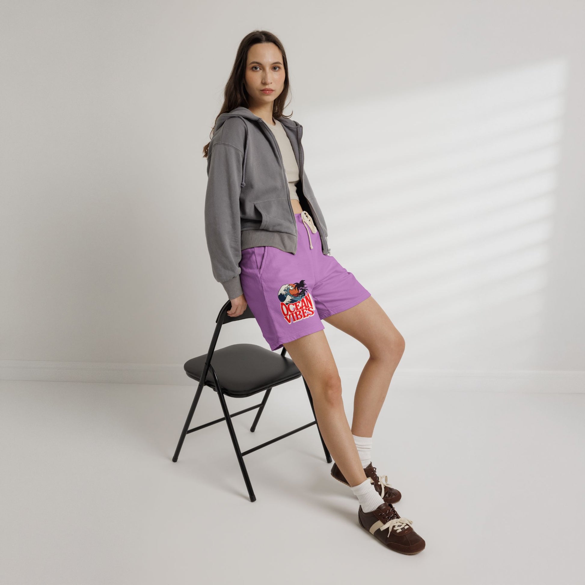 Person wearing a gray hoodie and purple shorts with a colorful design, standing on a white background. Unique Lightweight Fleece Sweat Shorts in Ocean Vibes Graphic Shop Lightweight Fleece Sweat Shorts in Ocean Vibes for breezy comfort, relaxed style, and an easygoing summer-ready look all day. Refresh your casual rotation with Lightweight Fleece Sweat Shorts in Ocean Vibes—soft, versatile, and ready for sunny days by the shore. Buy Lightweight Fleece Sweat Shorts in Ocean Vibes, made for soft comfort.