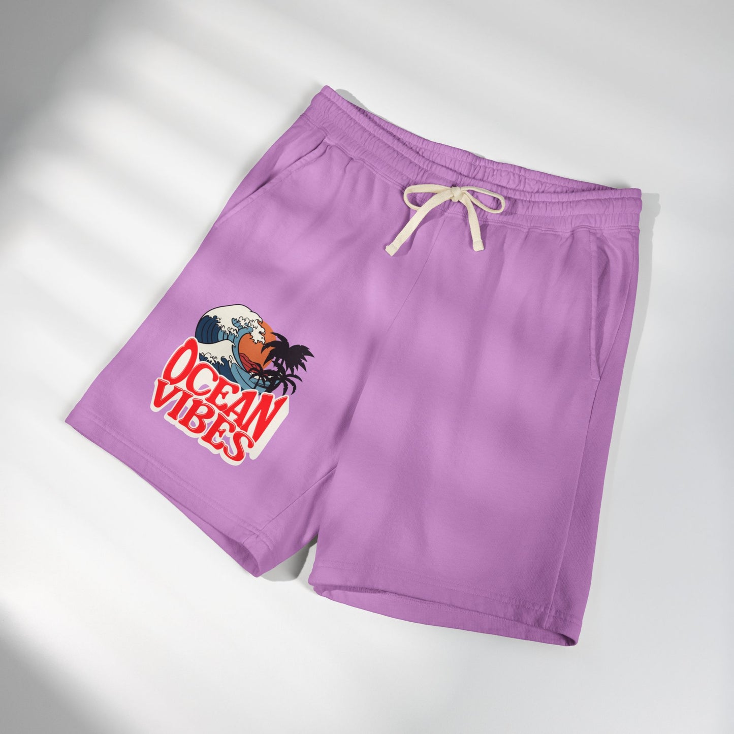 Purple athletic shorts with a cream drawstring and a graphic print on the left leg featuring a crab and the text 'OCEAN VIBES'. Unique Lightweight Fleece Sweat Shorts in Ocean Vibes Graphic Shop Lightweight Fleece Sweat Shorts in Ocean Vibes for breezy comfort, relaxed style, and an easygoing summer-ready look all day. Refresh your casual rotation with Lightweight Fleece Sweat Shorts in Ocean Vibes—soft, versatile, and ready for sunny days by the shore. Buy Lightweight Fleece Sweat Shorts in Ocean Vibes.