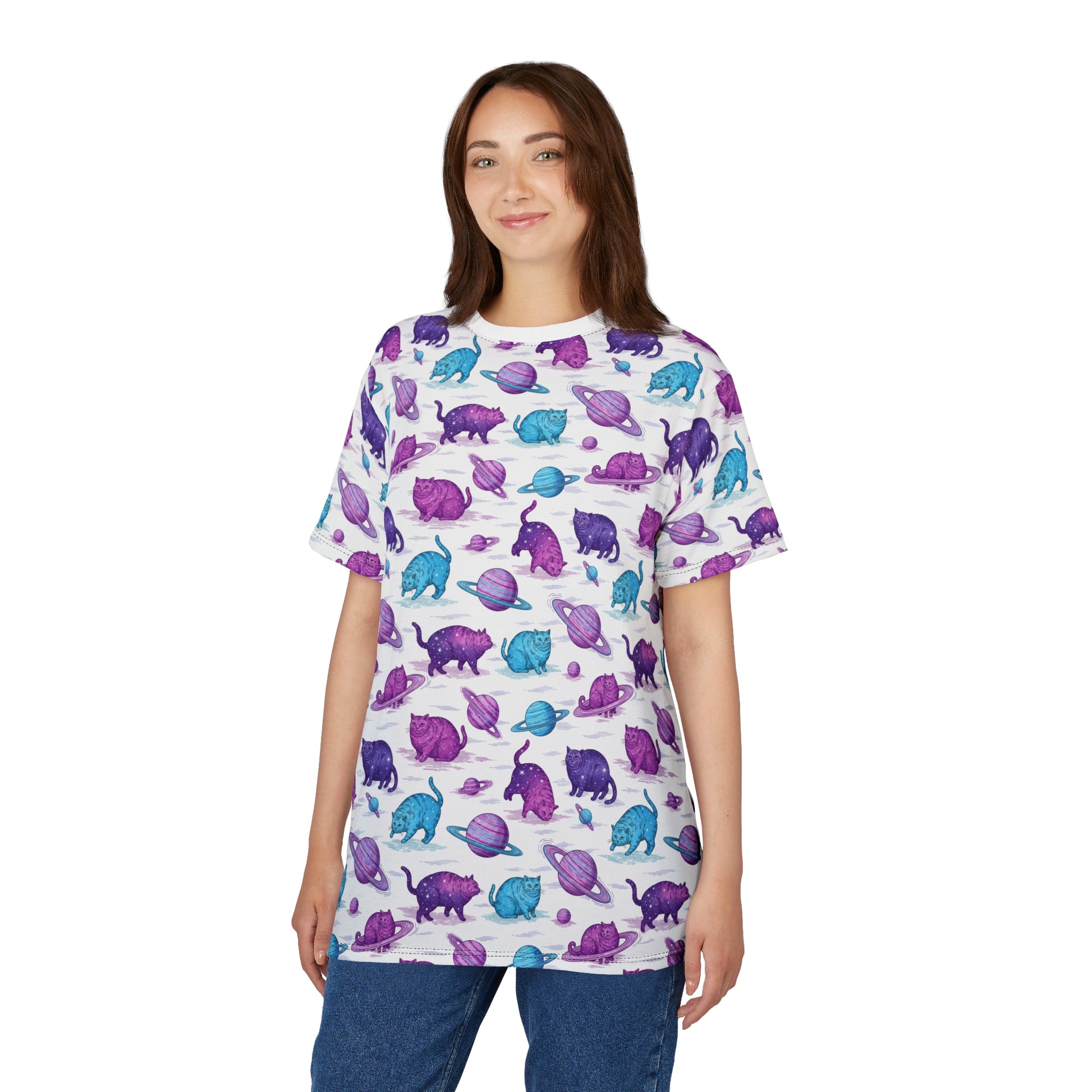 A woman modeling a white short-sleeve t-shirt with an all-over print of purple and blue dinosaur figures, paired with blue jeans, against a plain white background. Artistic Chubby Cats Orbiting Planets Graphic T-Shirt for Casual Wear
