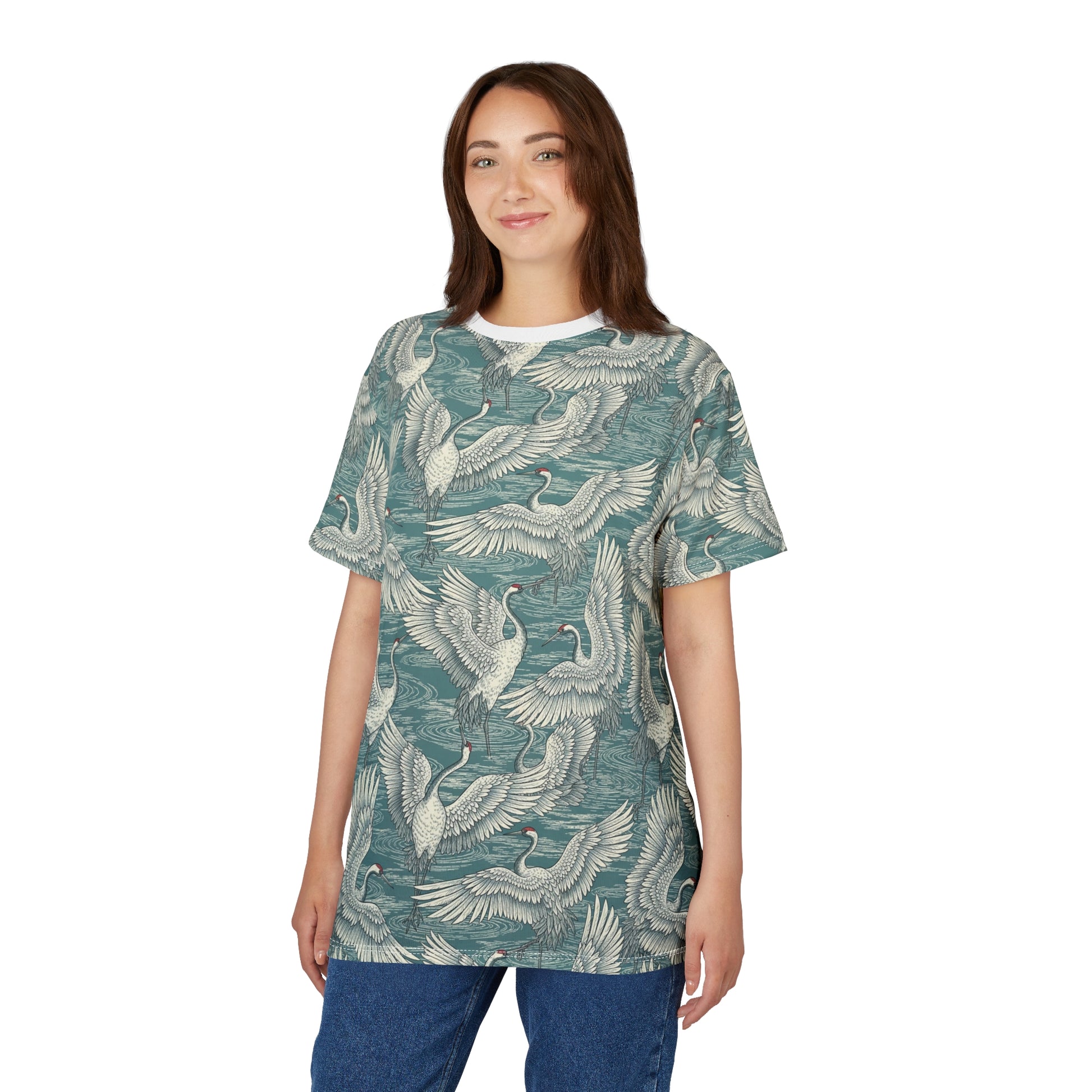 A woman modeling a short-sleeve t-shirt with an all-over print of cranes in flight over water, featuring a teal-green and off-white color palette, set against a plain white background. Beautiful Vintage Japanese Crane Pattern T-Shirt Casual Wear