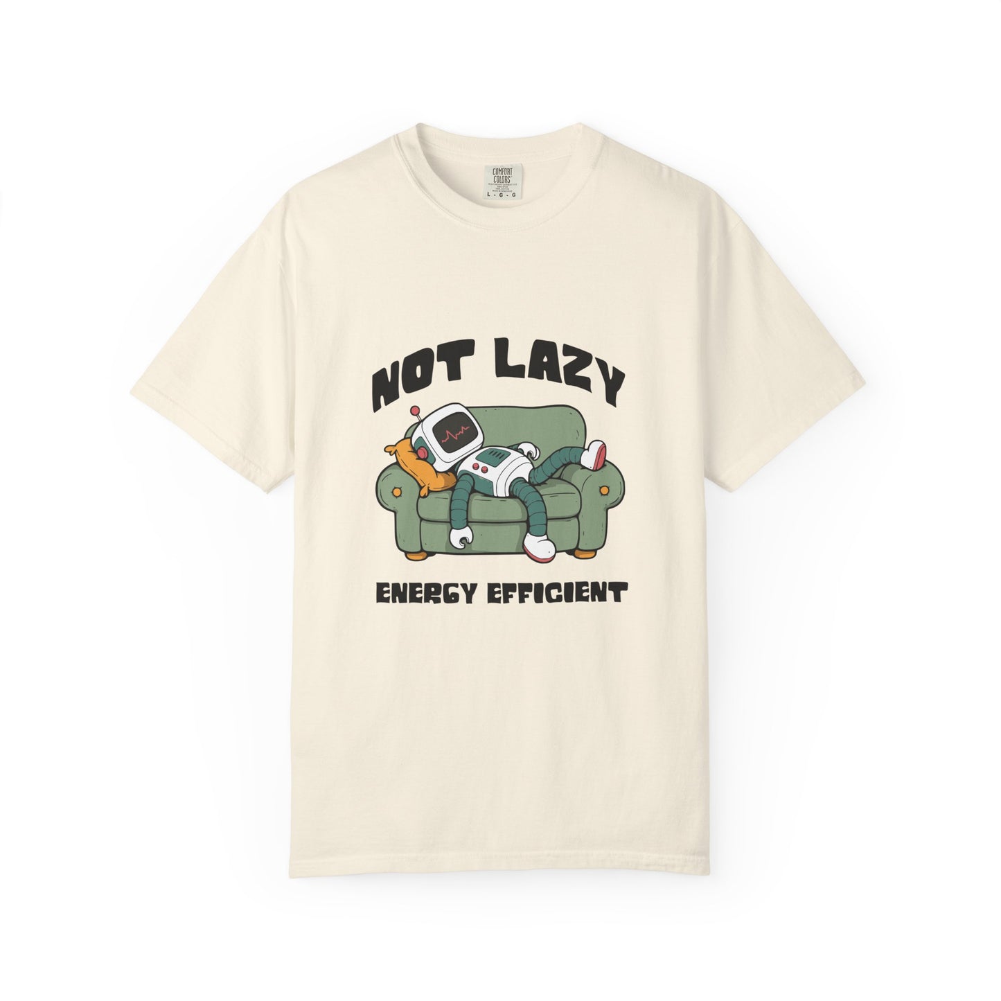 An off-white short-sleeve t-shirt with a cartoon graphic of a person lazily sleeping on a green couch with a retro television, accompanied by the text 'NOT LAZY ENERGY EFFICIENT'.