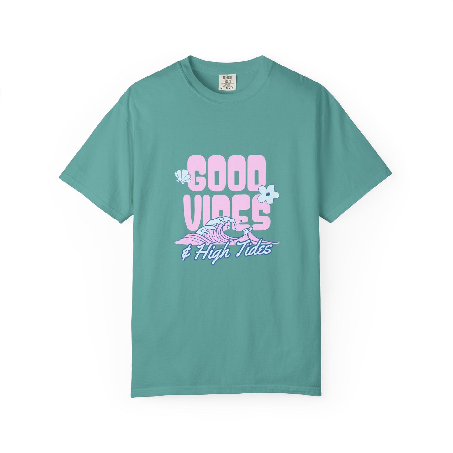 A teal green short-sleeve t-shirt with a retro-style graphic on the chest reading 'GOOD VIBES & High Tides' in pink and purple, featuring a wave and flower illustration, displayed on a clean white background.