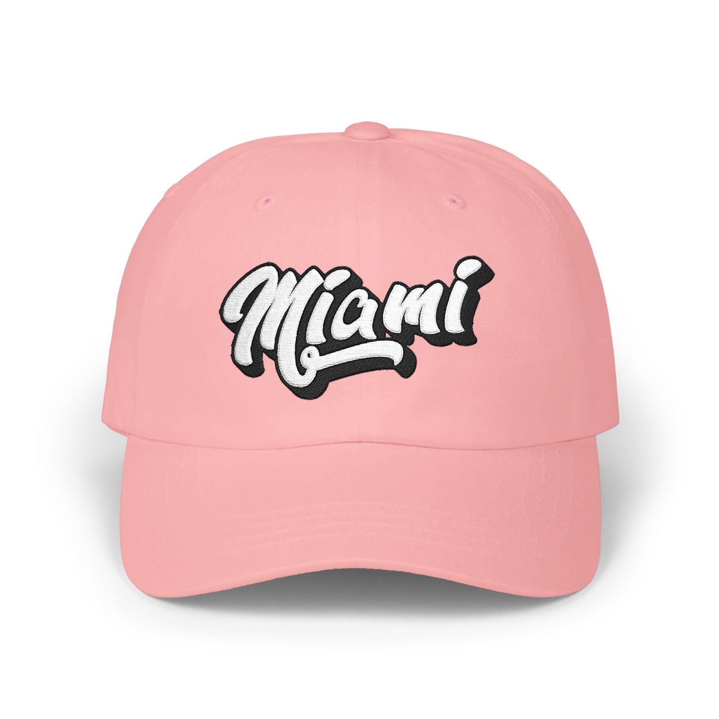 A pink baseball cap featuring the word 'Miami' in a stylized white cursive font with a black outline on the front panel, shown against a plain white background. Classic Minimalist Miami Beach Typography Classic Dad Cap