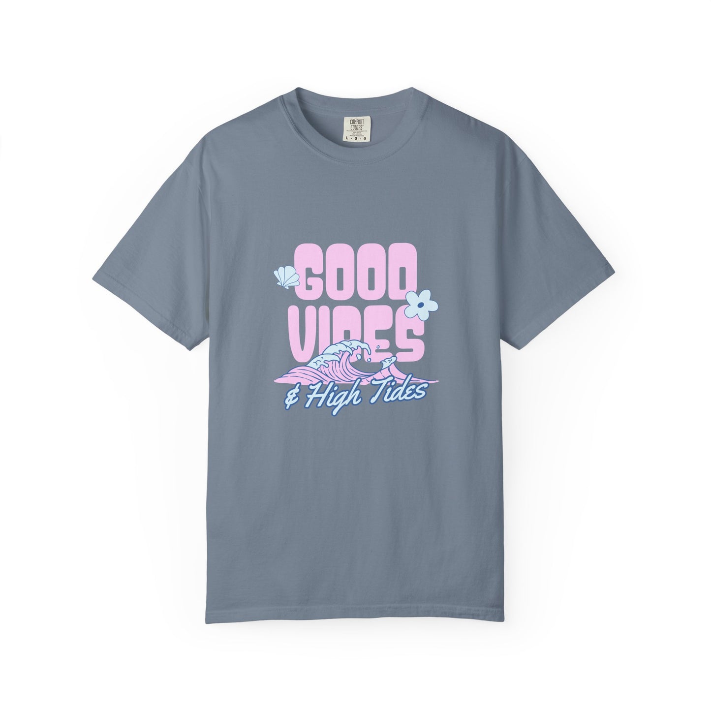 A slate blue crewneck t-shirt featuring a retro-style graphic on the chest that reads 'GOOD VIBES & High Tides' in pink and light blue, accompanied by a pink and blue wave and flower illustrations, displayed on a clean white background.