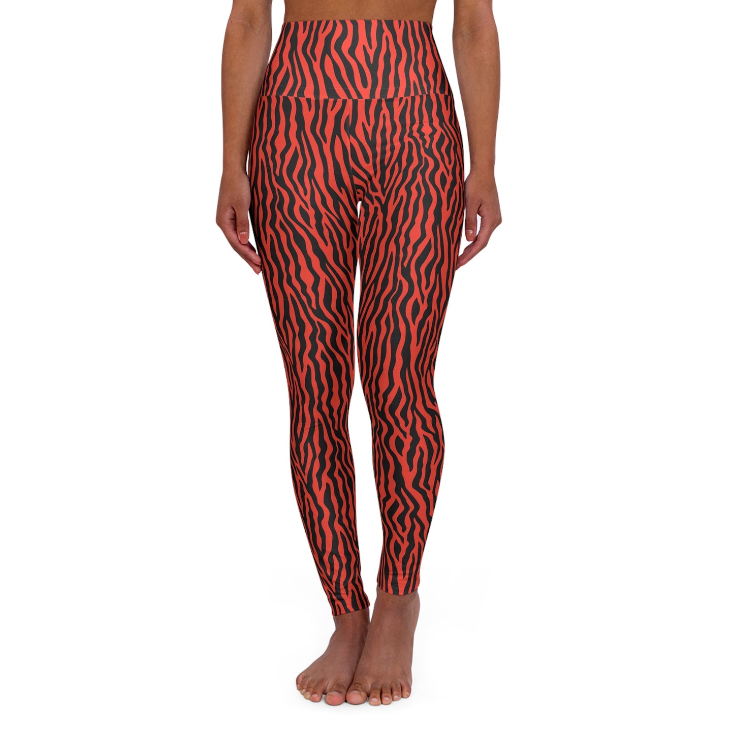 A model from the waist down wearing high-waisted leggings with a bold red and black wavy animal print pattern, standing barefoot against a plain white background. Comfortable Bold Red Zebra Stripes High-Waist Yoga Leggings