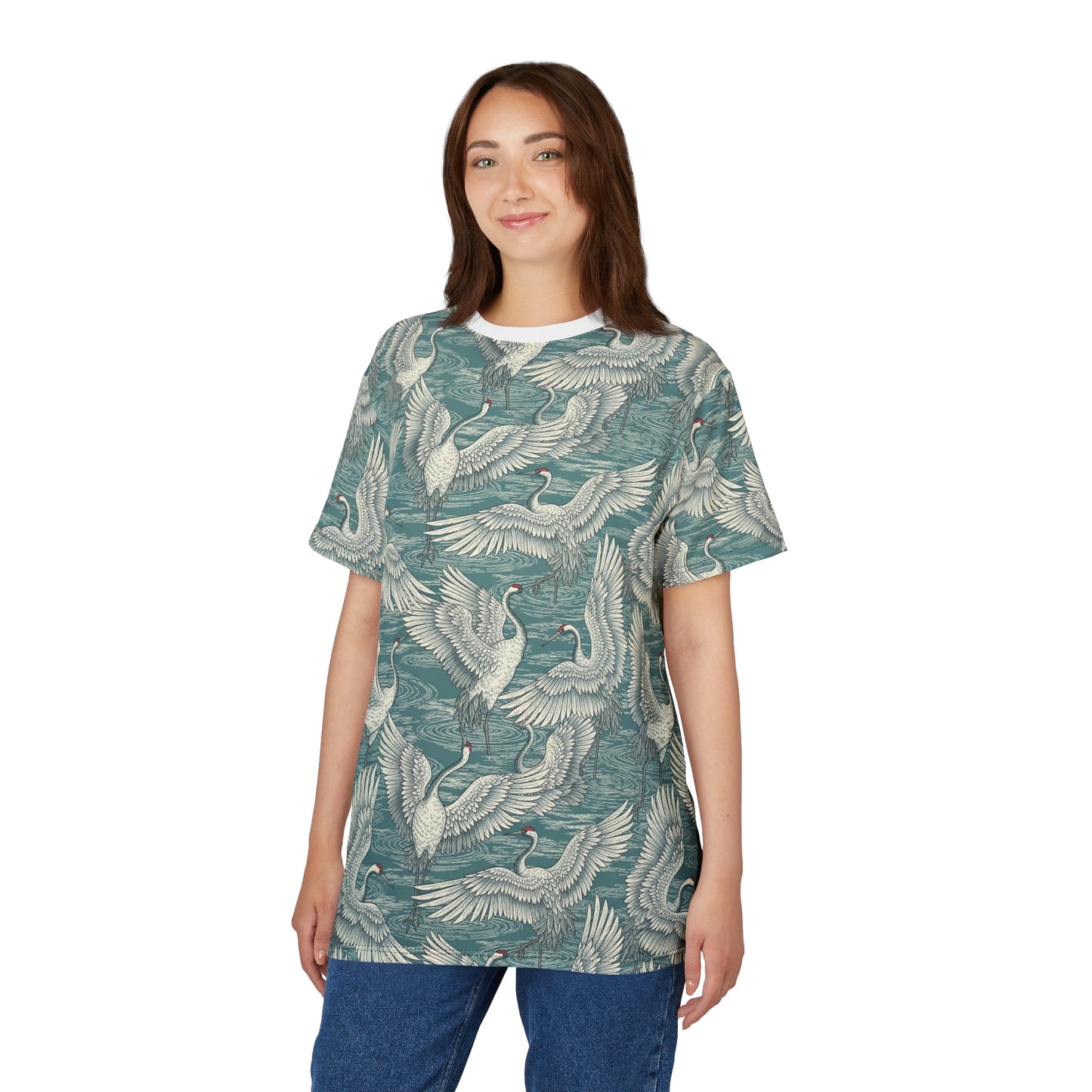 A woman modeling a short-sleeve t-shirt with an all-over print of cranes in flight over water, featuring a teal-green and off-white color palette, set against a plain white background. Comfortable Vintage Japanese Crane Pattern T-Shirt Casual Wear