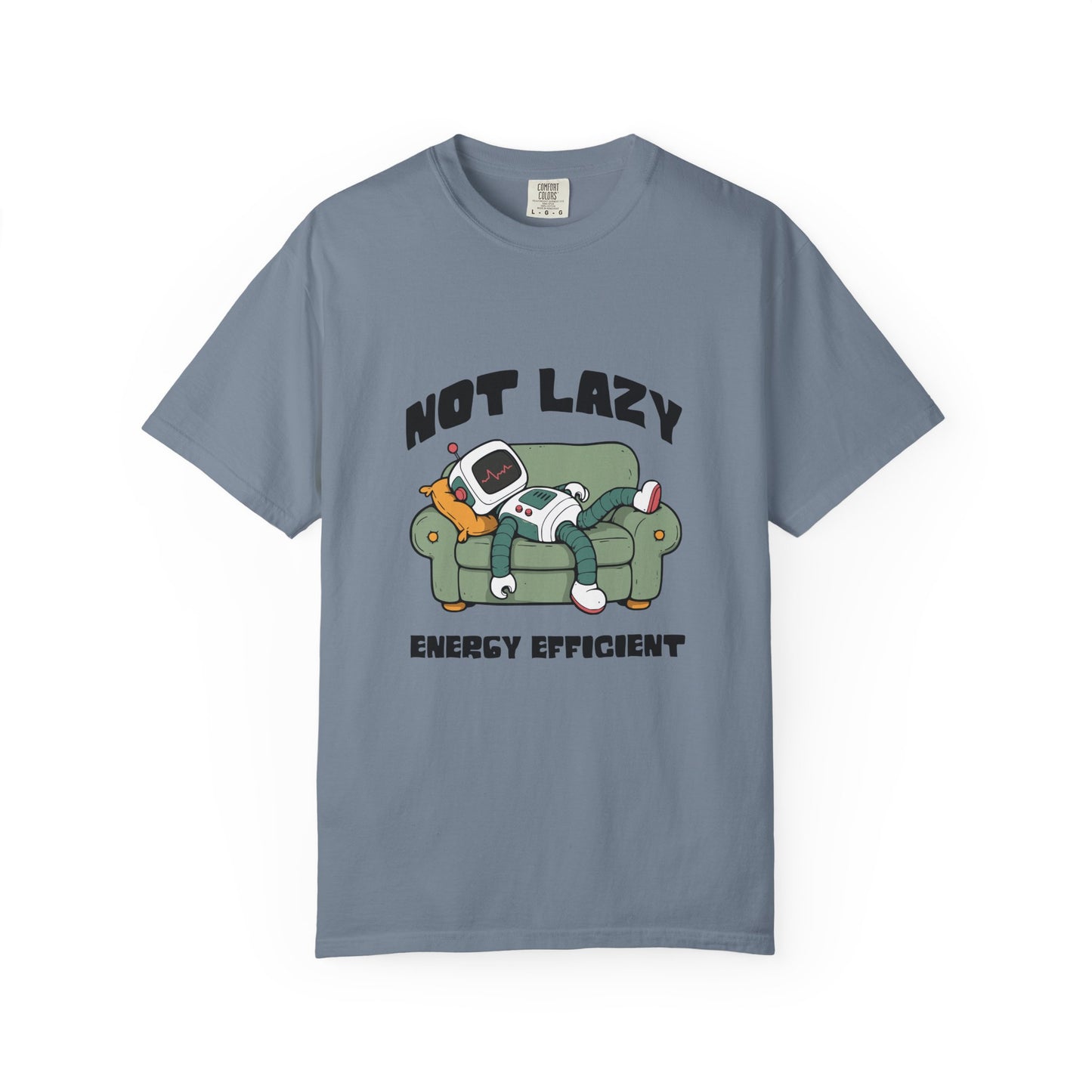 A slate blue crewneck t-shirt featuring a cartoon graphic of a person lazily reclining on a green couch with a retro television, with the text 'NOT LAZY ENERGY EFFICIENT' printed in black.