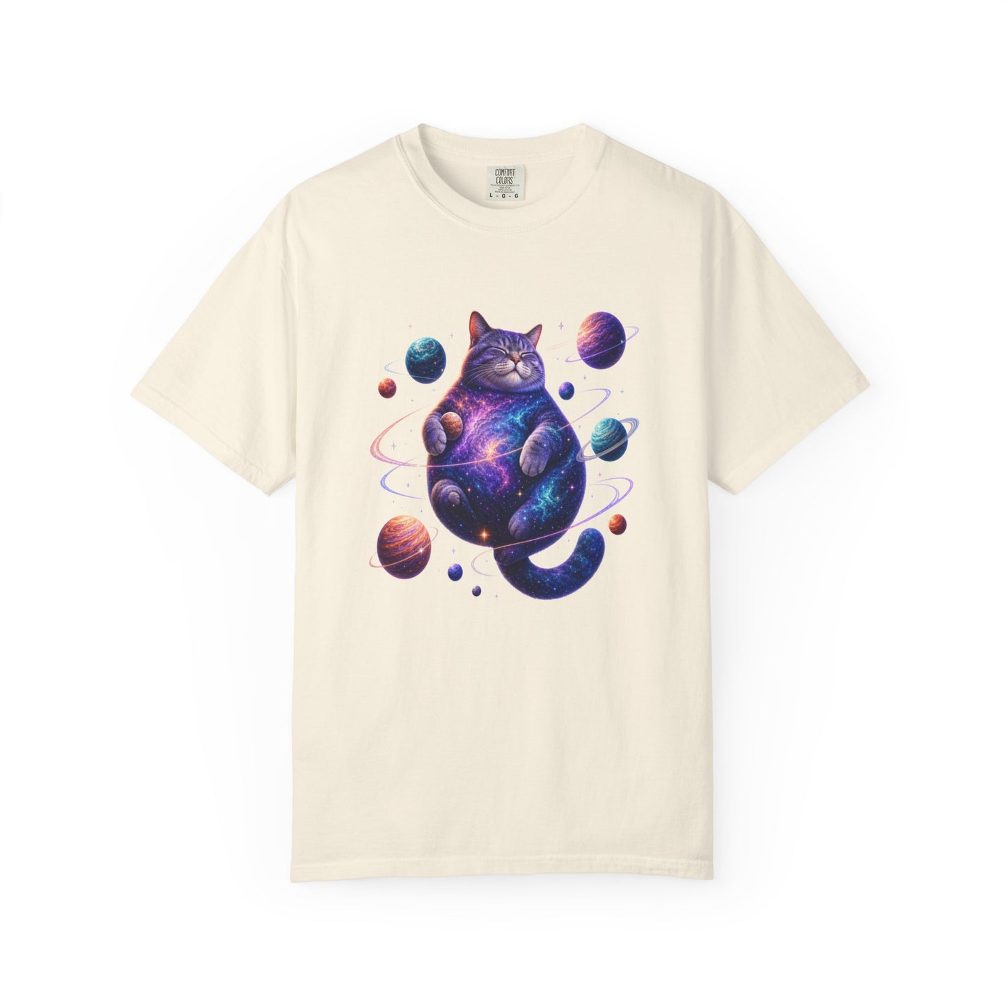 An off-white short-sleeve crewneck t-shirt featuring a colorful graphic of a cosmic, galaxy-patterned cat sitting among planets. Cute Celestial Feline: Space-Themed Cat T-Shirt for Casual Wear