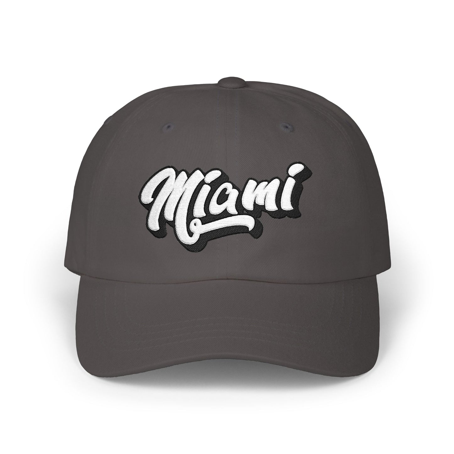 A dark gray baseball cap featuring the word 'Miami' in a white cursive script with a black outline on the front panel, set against a plain white background. Effortless Minimalist Miami Beach Typography Classic Dad Cap