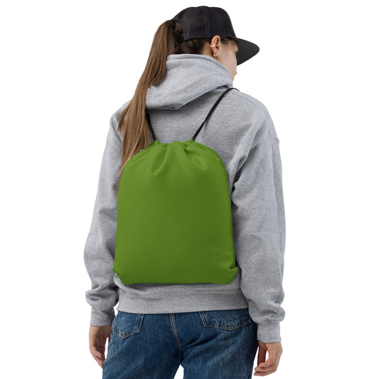 A person viewed from the back wearing a gray hoodie, blue jeans, and a black baseball cap, carrying a bright green drawstring backpack against a plain white background. Essential Minimalist Bold Solid Olive Drab Drawstring Bag