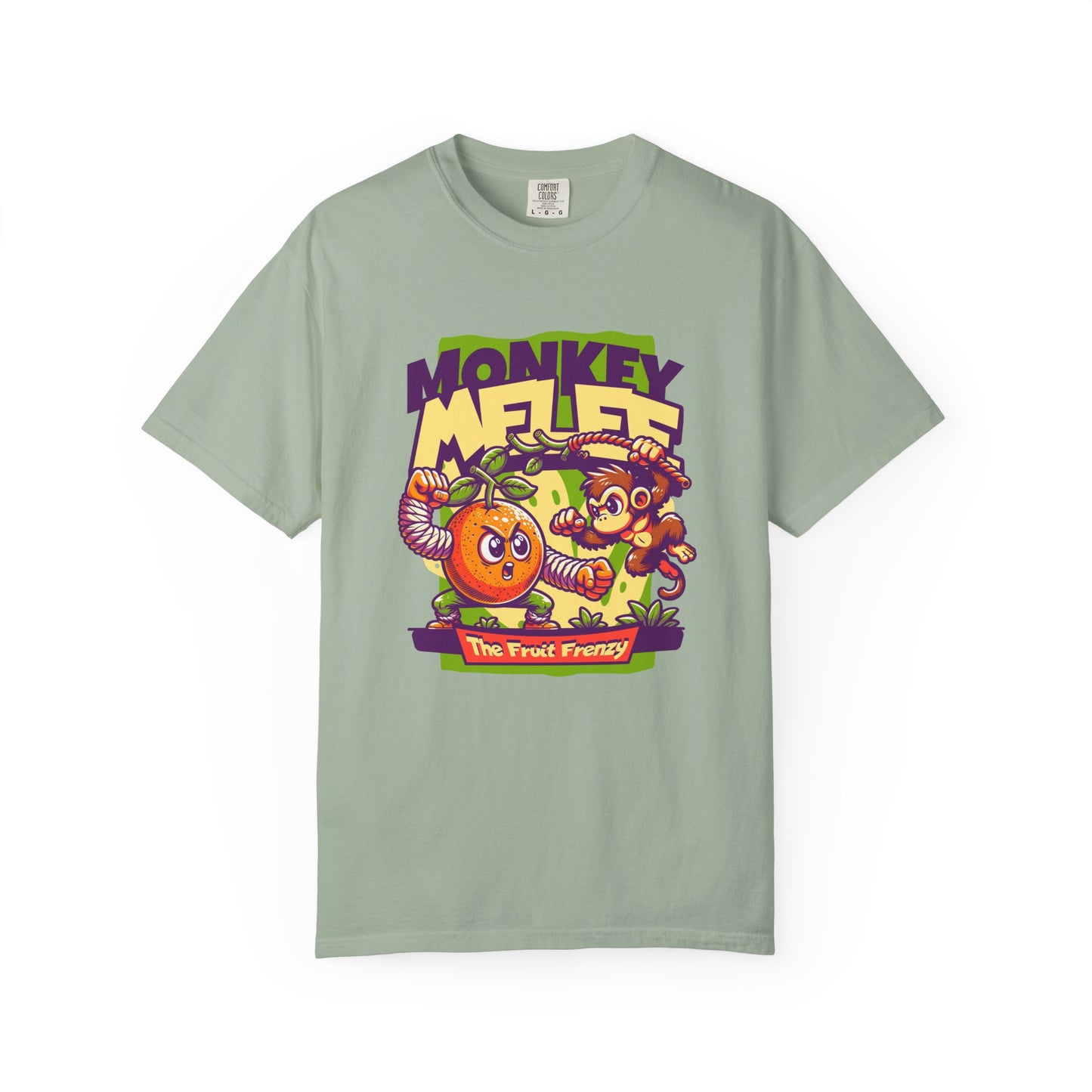 A sage green crewneck t-shirt featuring a colorful graphic print of a cartoon monkey and an orange with the text 'MONKEY MELEE The Fruit Fantasy'. Fun Monkey Melee The Fruit Frenzy Graphic T-Shirt for Casual Wear