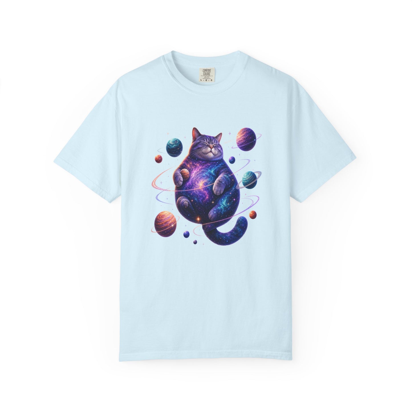 A light blue short-sleeve crewneck t-shirt featuring a colorful graphic of a cosmic, galaxy-patterned cat surrounded by planets, displayed on a clean white background. Out-of-This-World Celestial Feline: Space-Themed Cat T-Shirt for Casual Wear