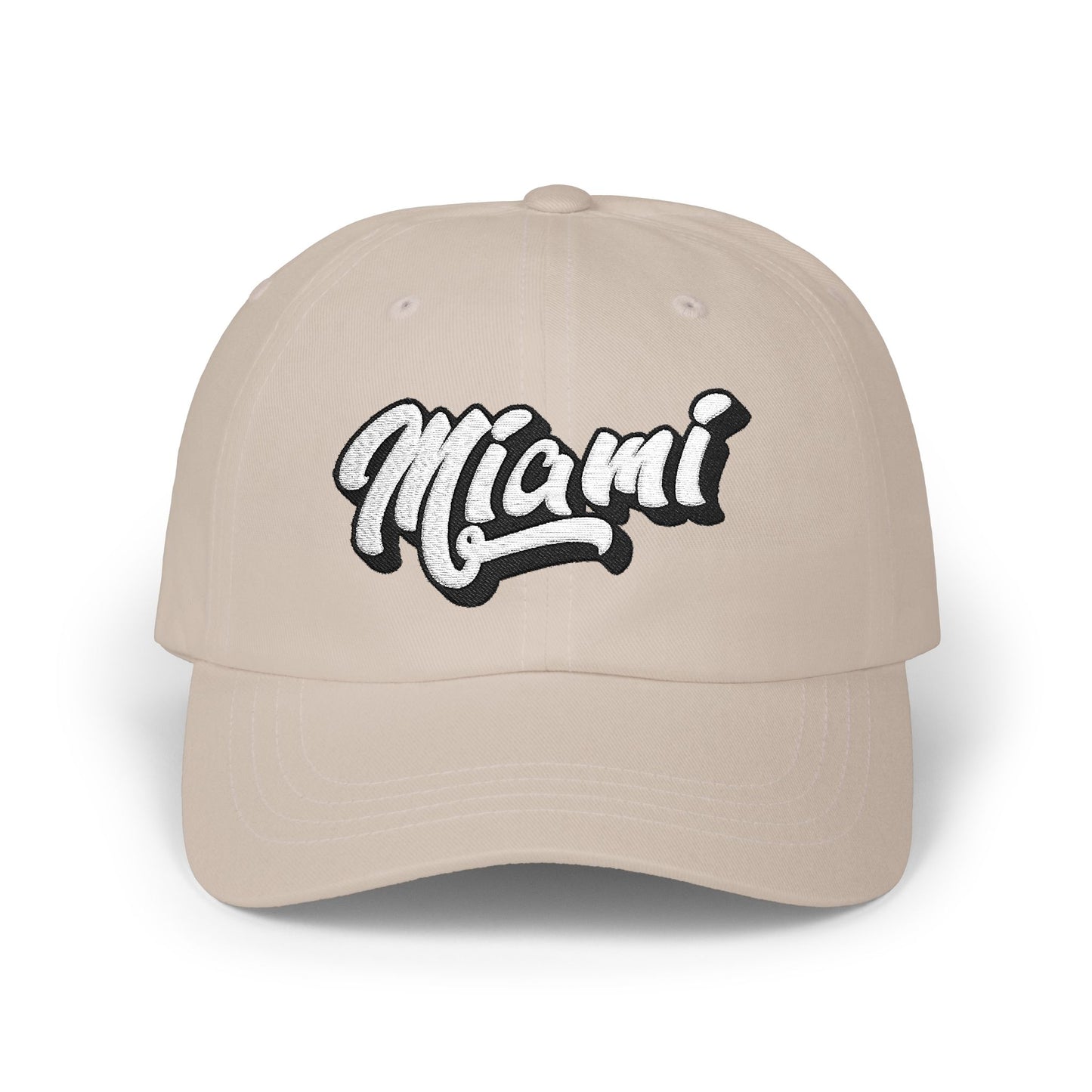 A beige baseball cap featuring the word 'Miami' embroidered in a stylized white script with a black outline on the front panel, set against a plain white background. Retro Minimalist Miami Beach Typography Classic Dad Cap