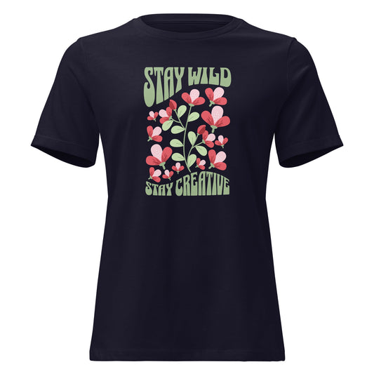 A navy blue short-sleeve t-shirt with a retro graphic on the chest featuring pink and red flowers, green leaves, and the text 'STAY WILD' and 'STAY CREATIVE' in a light green retro font, shown against a plain white background. Stay Wild Stay Creative Women's Relaxed T-Shirt Casual Wear