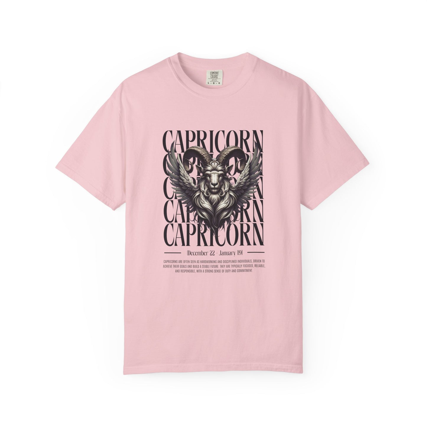 A light pink short-sleeve crewneck t-shirt featuring a black graphic print of a ram's head with wings and the word 'CAPRICORN' repeated vertically, displayed on a clean white background.