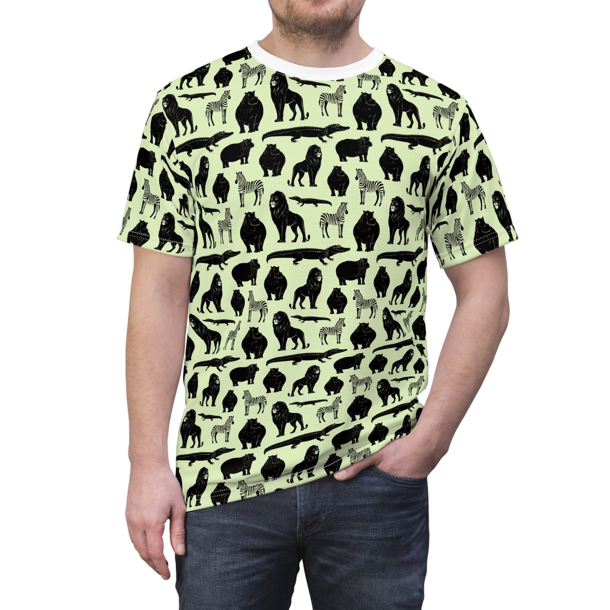 A man wearing a short-sleeve crewneck t-shirt with an all-over animal silhouette print. The shirt features black and gray silhouettes of gorillas, zebras, and crocodiles on a pale yellow-green background. Trendy Bold Jungle Safari Animal Pattern T-Shirt for Casual Wear