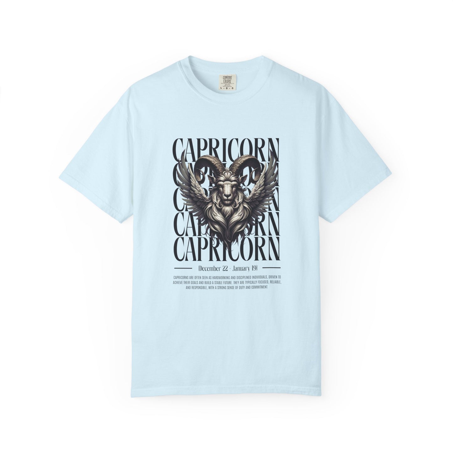 A light blue short-sleeve crewneck t-shirt featuring a detailed black and gray graphic of a ram's head with the word 'CAPRICORN' repeated vertically behind it, displayed on a clean white background.