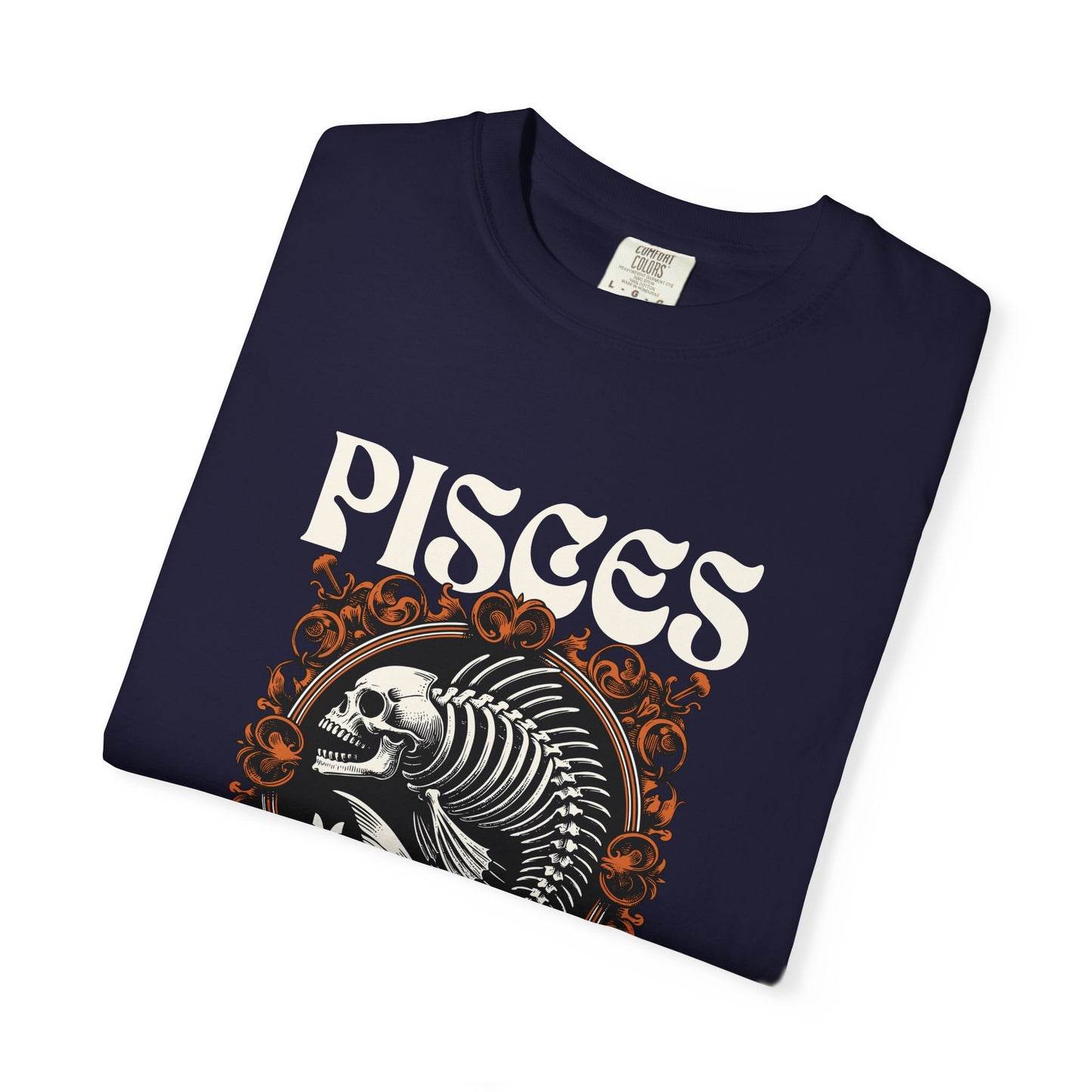 A folded black t-shirt featuring a graphic print of a white skeleton and the word 'PISCES' in a stylized white font, with orange decorative swirls, on a plain white background.
