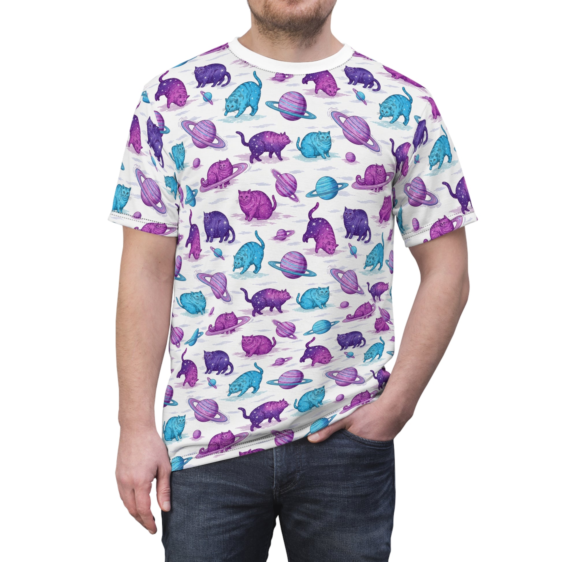 A man wearing a white crewneck t-shirt with an all-over print of purple and blue cats with planets, paired with dark blue jeans, against a plain white background. Unique Chubby Cats Orbiting Planets Graphic T-Shirt for Casual Wear