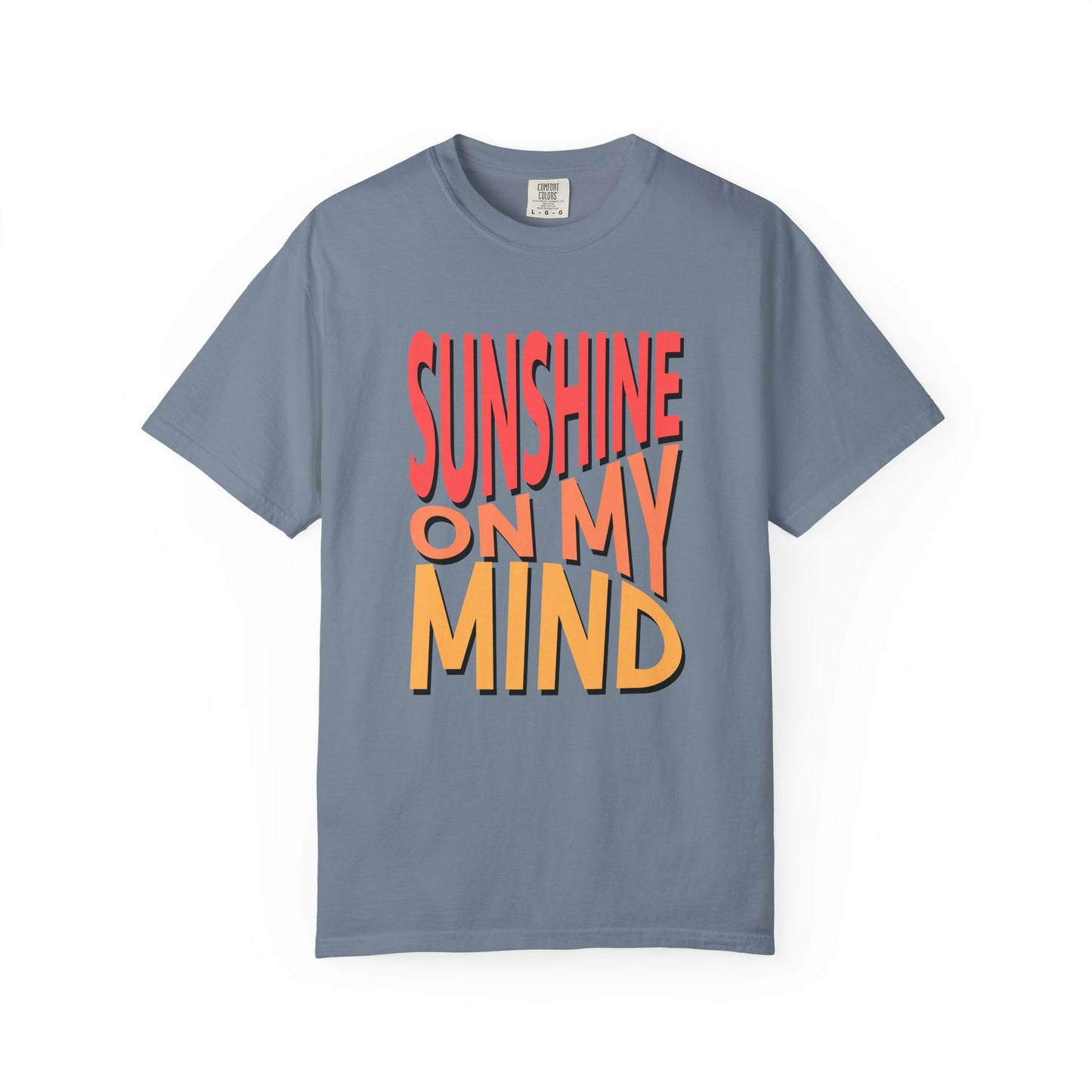 A slate blue short-sleeve t-shirt with a bold graphic text print reading 'SUNSHINE ON MY MIND' in red and orange 3D-style lettering, displayed on a clean white background. Unique Sunshine On My Mind Summer Vibes Graphic T-Shirt for Casual Wear
