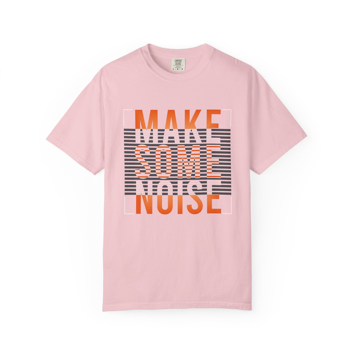 A light pink short-sleeve t-shirt with a graphic text print reading 'MAKE SOME NOISE' in orange and white over a black and white striped background block, displayed on a clean white background. Urban Fashion Make Some Noise Slogan Typography Graphic T-Shirt Casual Wear