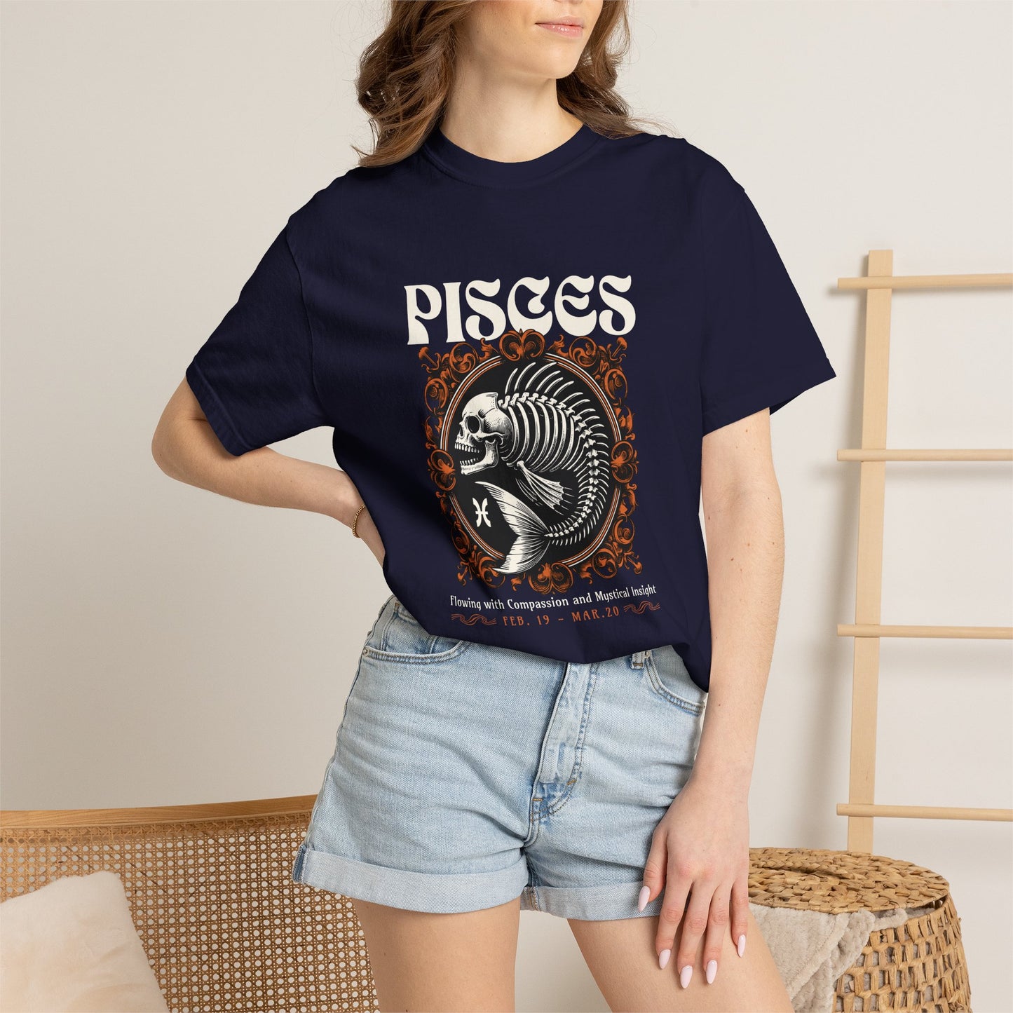 A woman wearing a black graphic t-shirt with a teal blue text box that reads 'I Am Not My Own Bought with a price, covered by grace' and light blue denim shorts, standing in a brightly lit room.