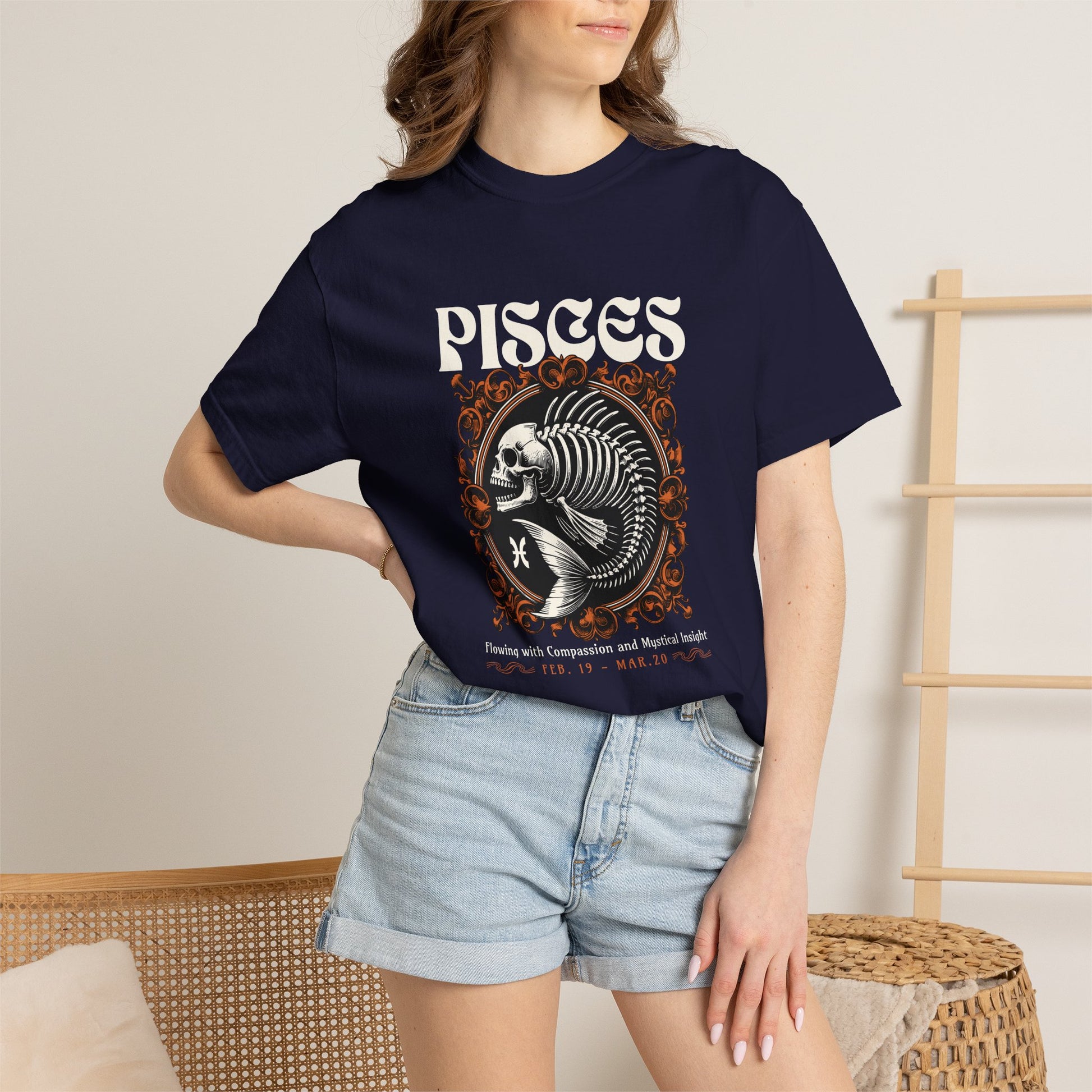 A woman wearing a black graphic t-shirt with a teal blue text box that reads 'I Am Not My Own Bought with a price, covered by grace' and light blue denim shorts, standing in a brightly lit room.