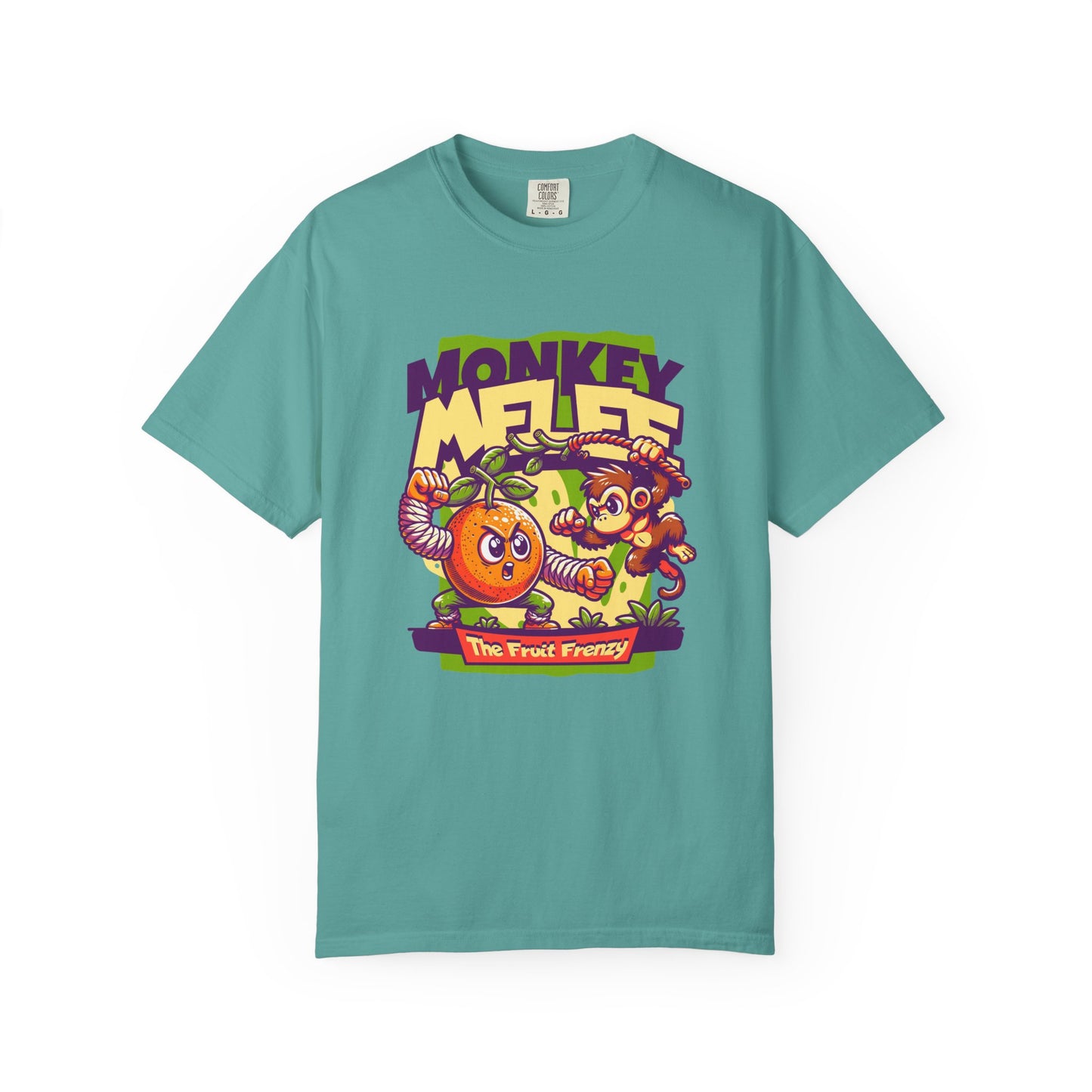 A teal short-sleeve t-shirt with a colorful cartoon graphic on the chest featuring a monkey, a mandarin orange, and the text 'MONKEY MELEE' and 'The Fruit Frenzy'. Whimsical Primate Adventure on Cotton Fabric