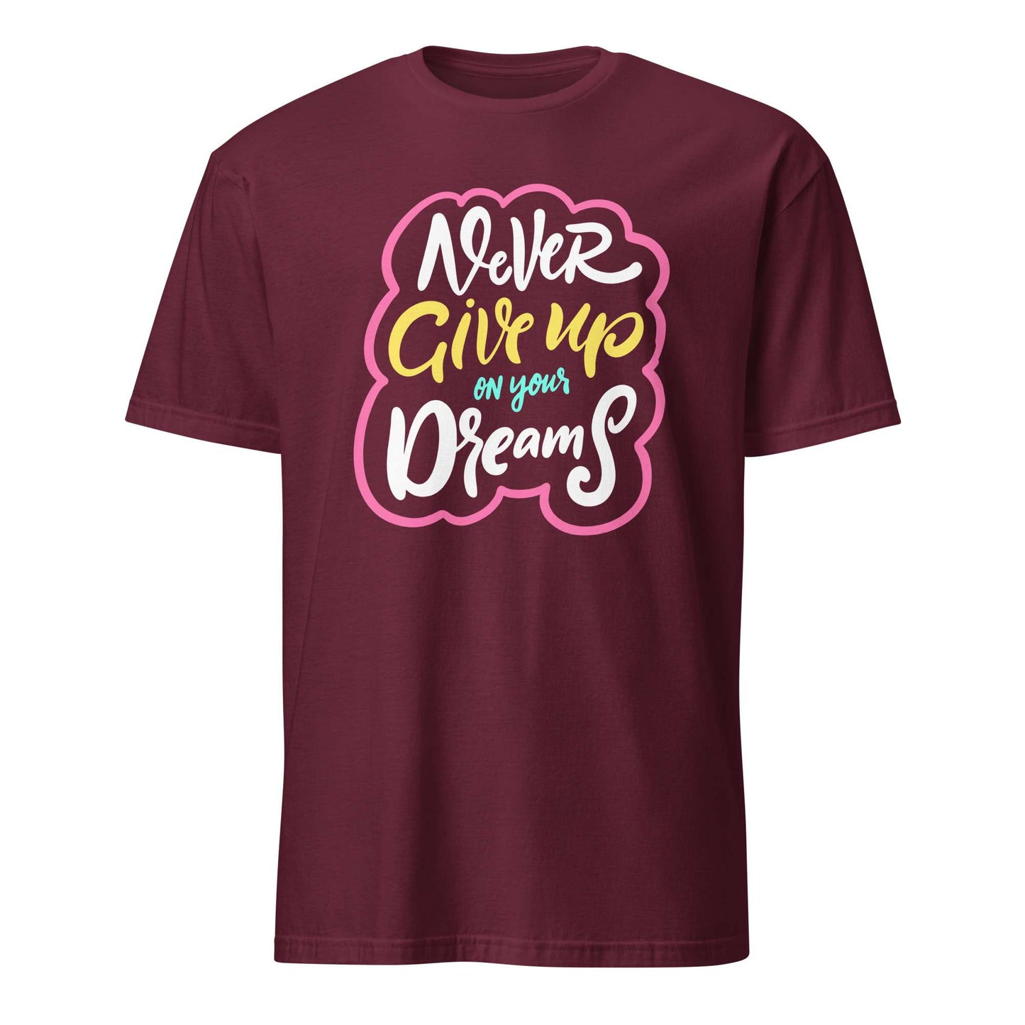 A maroon short-sleeve crewneck t-shirt featuring a colorful graphic on the chest that reads 'Never Give up on your Dreams' in white, yellow, and blue lettering with a pink outline, shown against a plain white background. Colorful Inspirational Typography Quote T-Shirt Casual Wear Shop the Colorful Inspirational Typography Quote T-Shirt Casual Wear collection for bold comfort, positive vibes, and everyday style. Shop Colorful Inspirational Typography Quote T-Shirt Casual Wear designed to brighten outfits.
